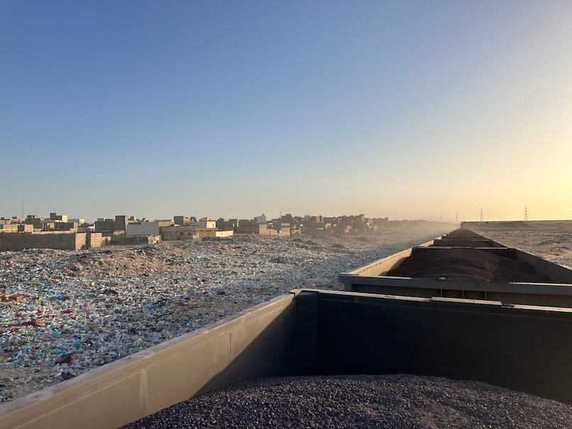 Plastic garbage covers the ground next to the railway in Nouadhibou.