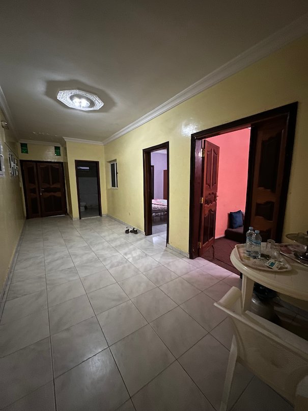 A tiled hallway leads to rooms in an apartment in Nouakchott.