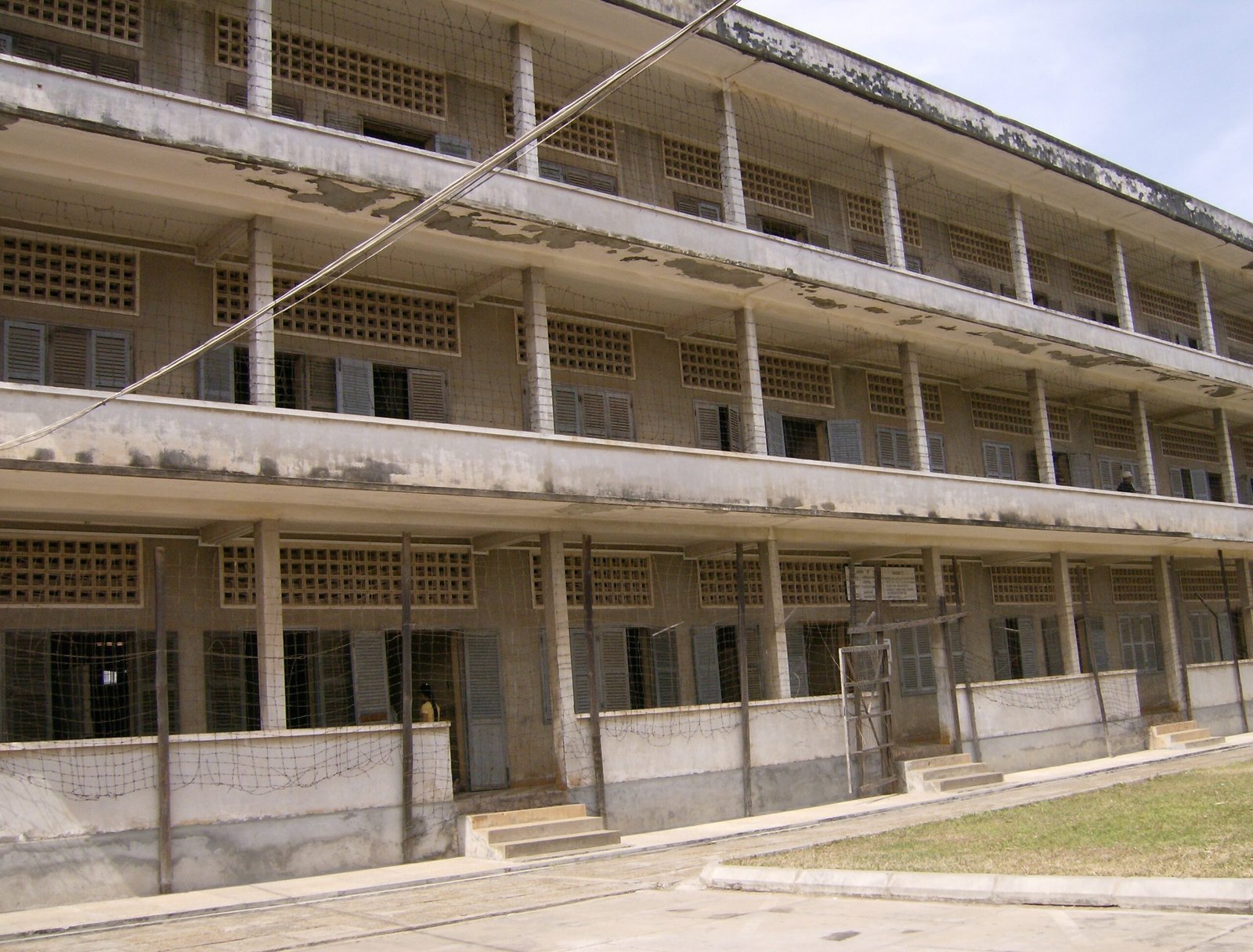 The former school building of Tuol Sleng Genocide Museum has three floors of open corridors.