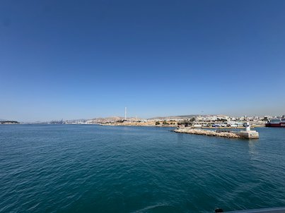 Entrance to Piraeus harbor with a small lighthouse on the breakwater