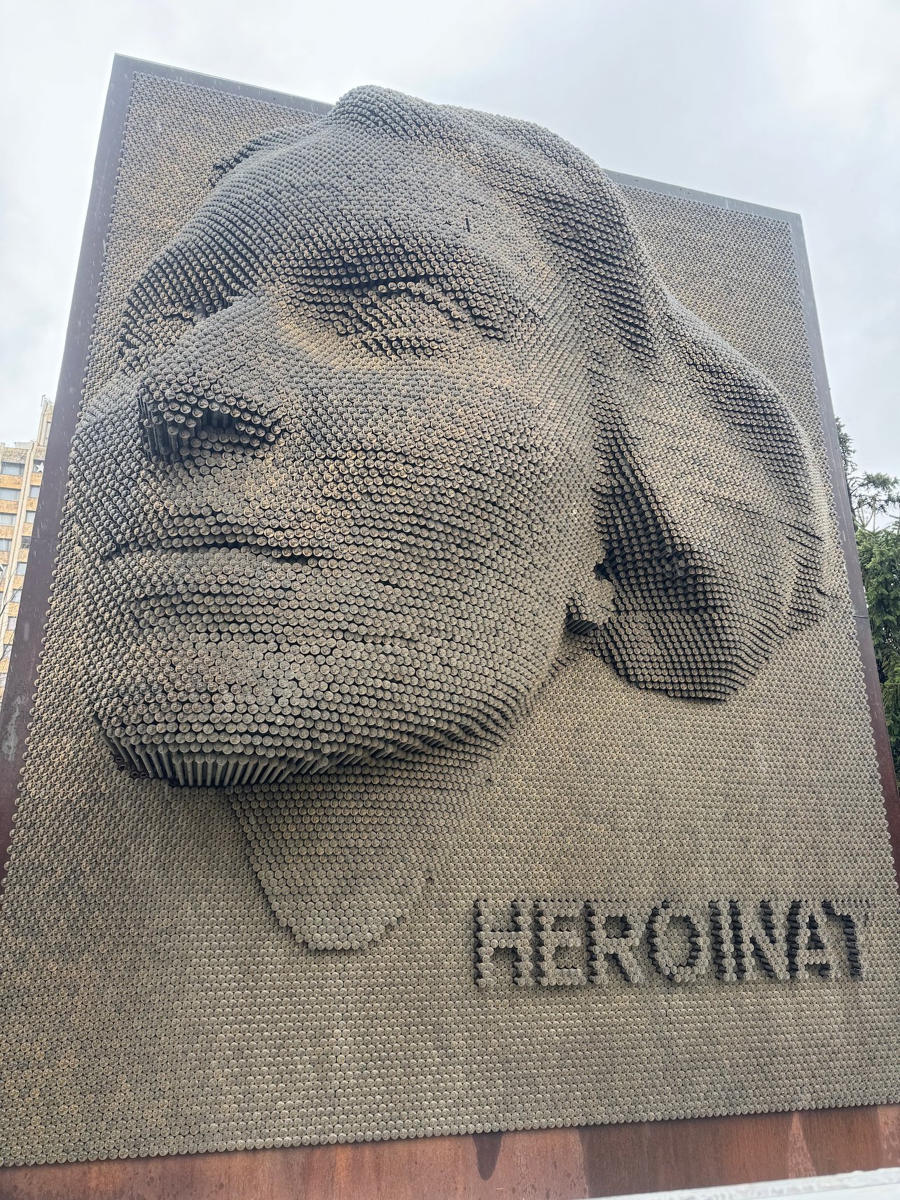 A woman's face made of thousands of small metal pins forms the Heroinat memorial in Pristina.