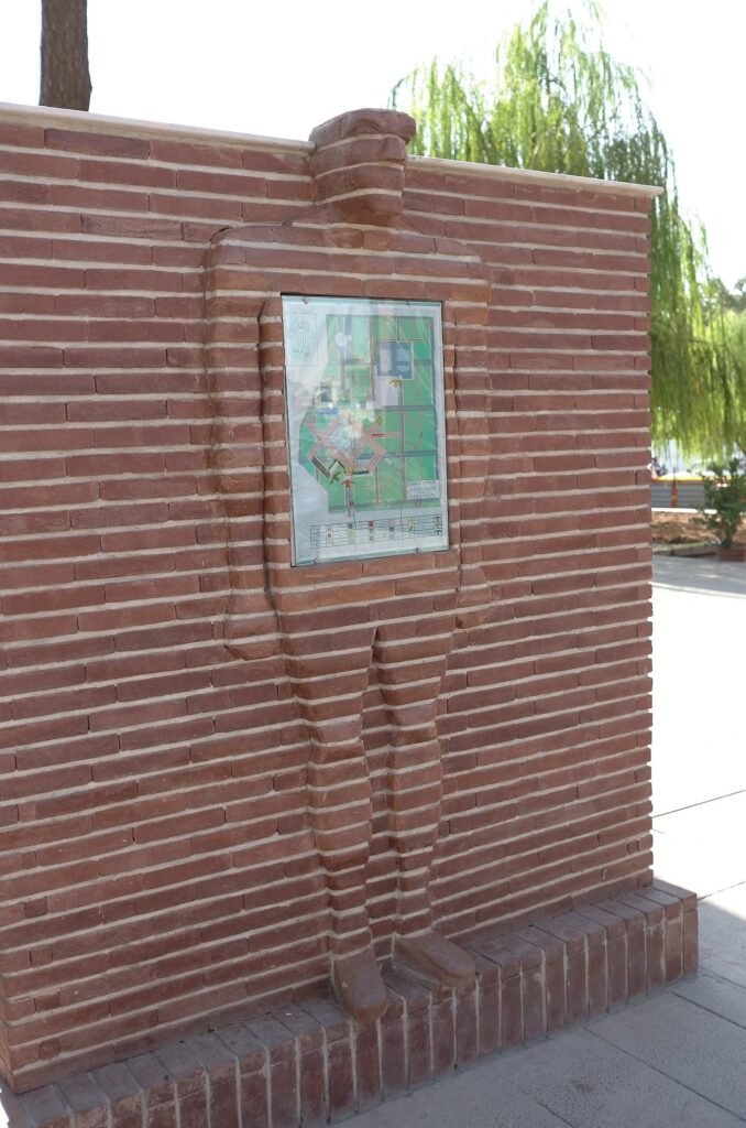 Brick wall with a map of the museum grounds at the Qasr Prison Museum