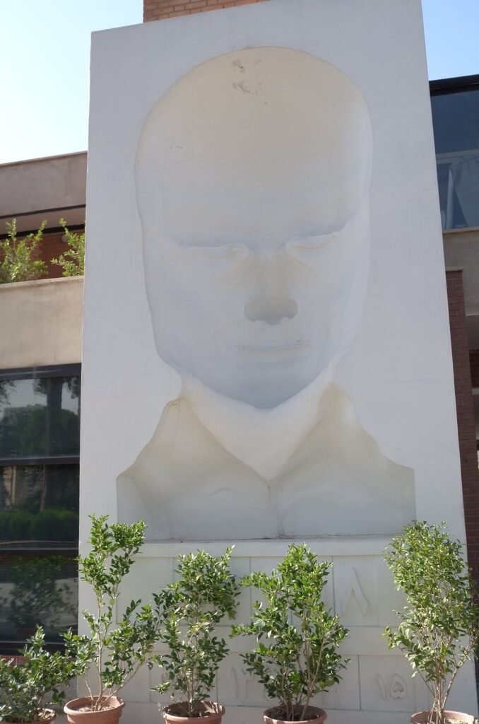 Large white sculpture of a face at the Qasr Prison Museum in Tehran