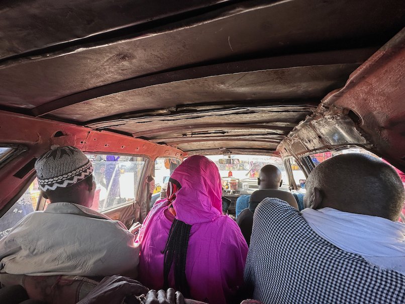 Passengers sit close together in an old bush taxi on the way to Rosso.