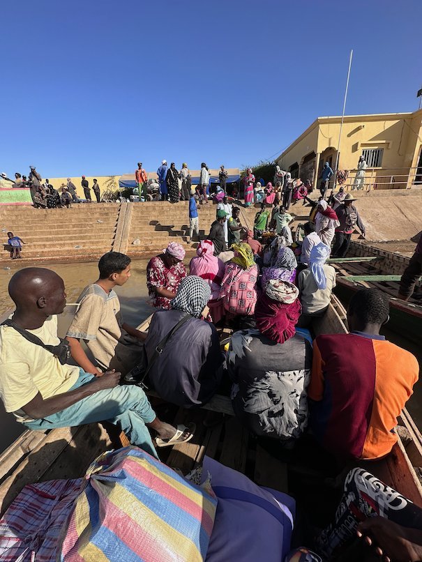 People and bags fill a pirogue that crosses the Senegal River at Rosso.