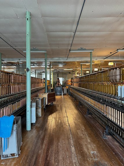 Aisle between old spinning machines in Rydals museum