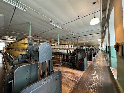 Long machine hall with old spinning machines in Rydals museum