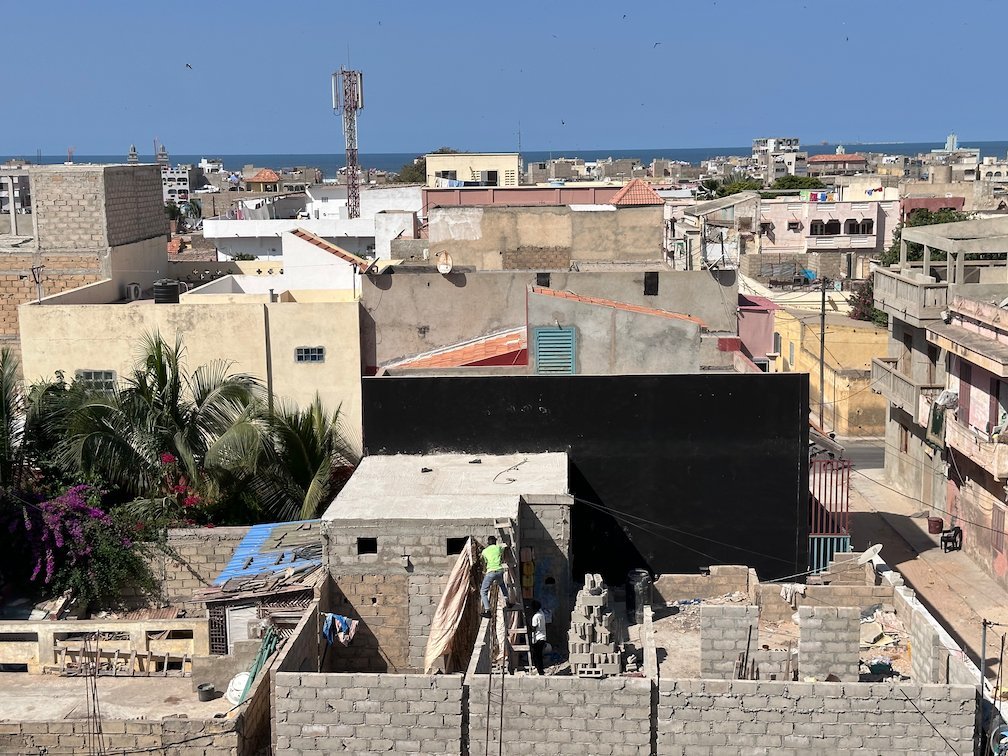 Flat roofs and houses fill the city view from a rooftop in Saint-Louis.