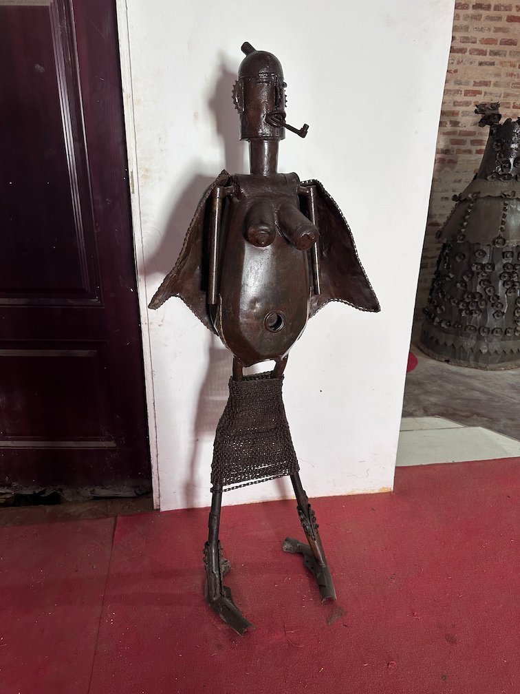 A metal sculpture of a figure with wings stands in a gallery in Saint-Louis.