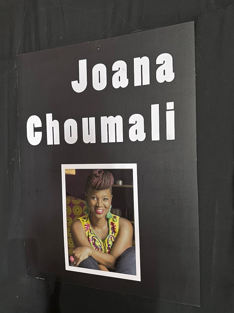A black panel with the name Joana Choumali and her portrait in a photo museum.