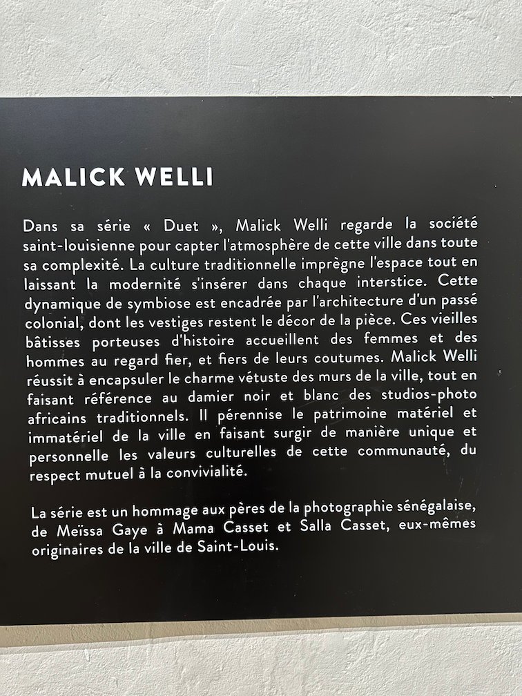 A black panel describes the photo series Duet by Malick Welli.
