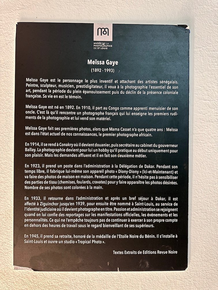 A black panel tells the life story of photographer Meissa Gaye in Saint-Louis.