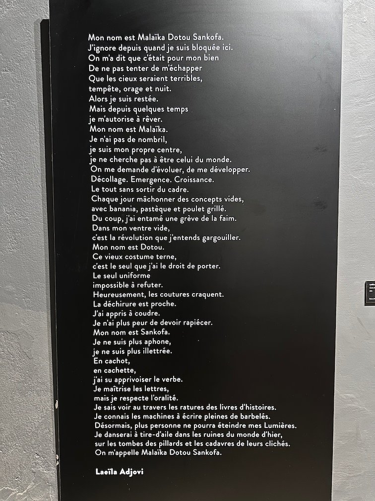 A black panel shows a long poem in a photo museum in Saint-Louis.