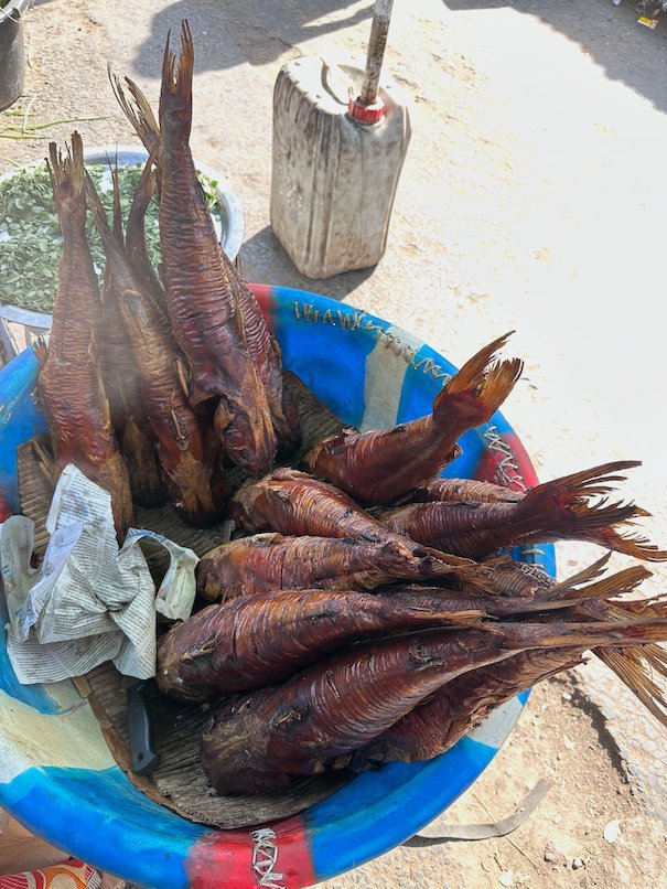 Smoked fish lie in a blue bowl at a market stall in Serrekunda, The Gambia.