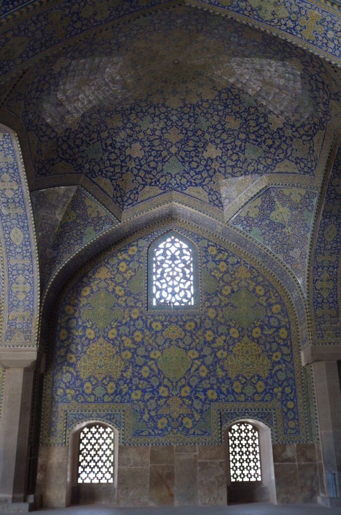 Prayer hall with blue tiles and small windows in the Shah Mosque