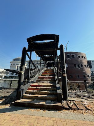 Stairs lead up a gangway to a wooden galleon on the Vardar River in Skopje.