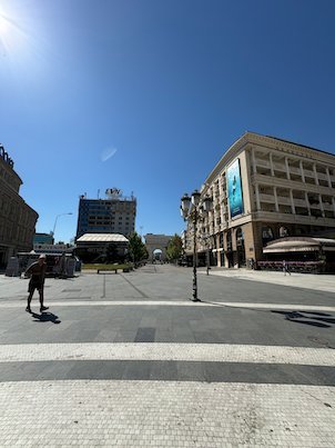 A man walks across the paved Macedonia Square in Skopje.