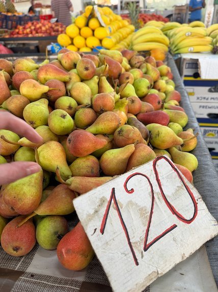 Pears with a price sign of 120 lie on a fruit stall at a market in Skopje.
