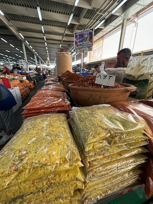 Bags of spices and dried peppers lie on a stall in a covered market in Skopje.