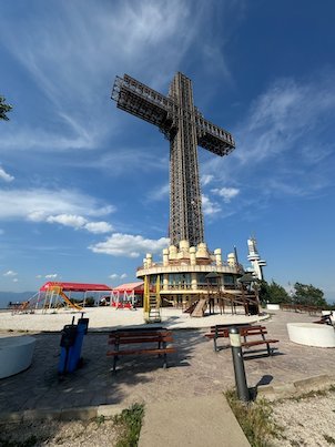 The Millennium Cross stands above a terrace with tables on top of Mount Vodno near Skopje.