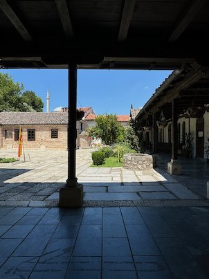 Dark arcades frame a sunny courtyard in the Old Bazaar in Skopje.