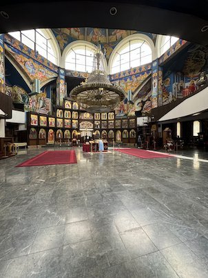 Frescoes, a chandelier and a marble floor fill the interior of St. Clement of Ohrid Church in Skopje.