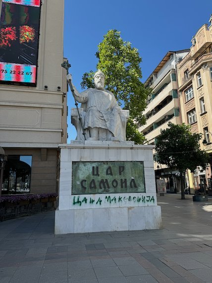 A white statue of Tsar Samuel stands on a stone base in central Skopje.