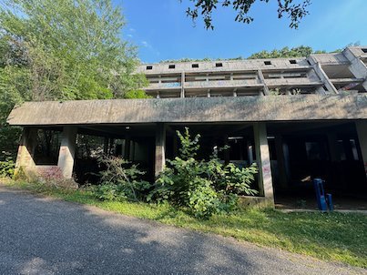 An abandoned concrete building stands beside a road in the forest on Mount Vodno near Skopje.