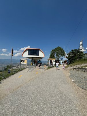 People walk on a road to the cable car station on top of Mount Vodno near Skopje.