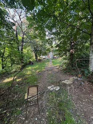 Old chairs stand in a grassy clearing in the forest on Mount Vodno near Skopje.