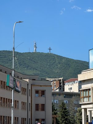 The Millennium Cross stands on top of Mount Vodno above city buildings in Skopje.