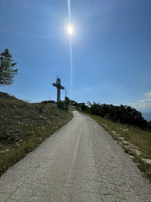 A paved road leads uphill to the Millennium Cross on Mount Vodno near Skopje.
