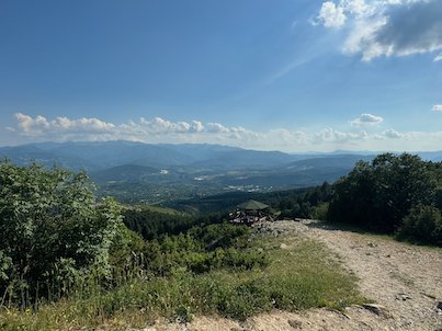 A dirt track leads to a wide view of hills and valley from Mount Vodno near Skopje.