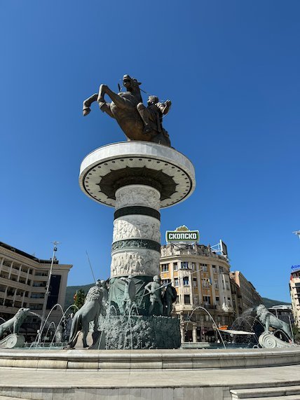 The Warrior on a Horse statue stands on a tall column above a fountain in Skopje.