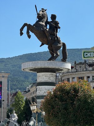 The Warrior on a Horse statue rises above Macedonia Square with Mount Vodno behind in Skopje.