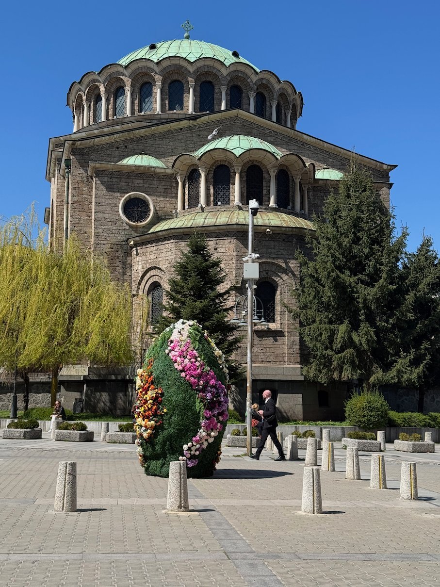 A large Easter egg made of flowers stands in front of Sveta Nedelya Cathedral in Sofia.