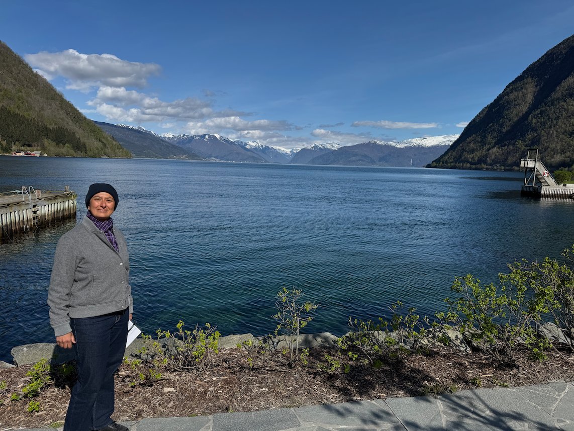 Zayera Khan stands by the Sognefjord at Vik, with mountains behind