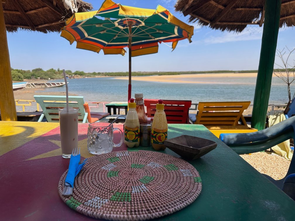 A colorful beach bar table looks out over the lagoon in Somone.