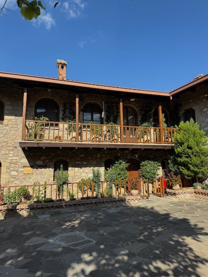 Courtyard with wooden balconies and plants at St. Stephen's Monastery