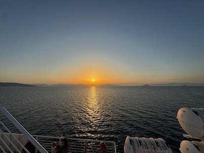 Orange sunset over the Saronic Gulf, seen from the deck of the ferry between Aegina and Piraeus