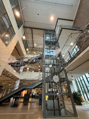 Atrium of the Textile Fashion Center with stairs and hanging art