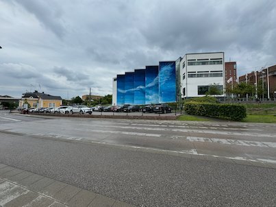 Textile Museum building with a huge blue sky mural, seen from the road