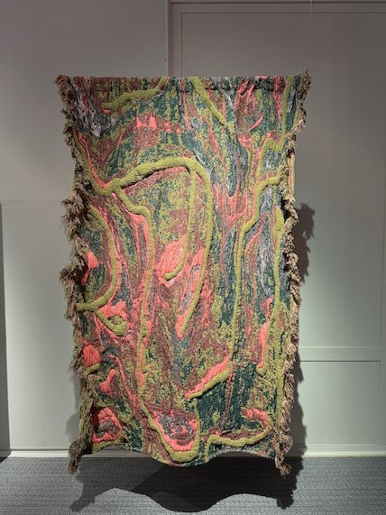 Textile wall hanging in green, pink and yellow