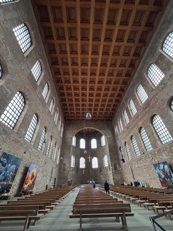 The long brick hall of the Aula Palatina has a coffered wooden ceiling in Trier.