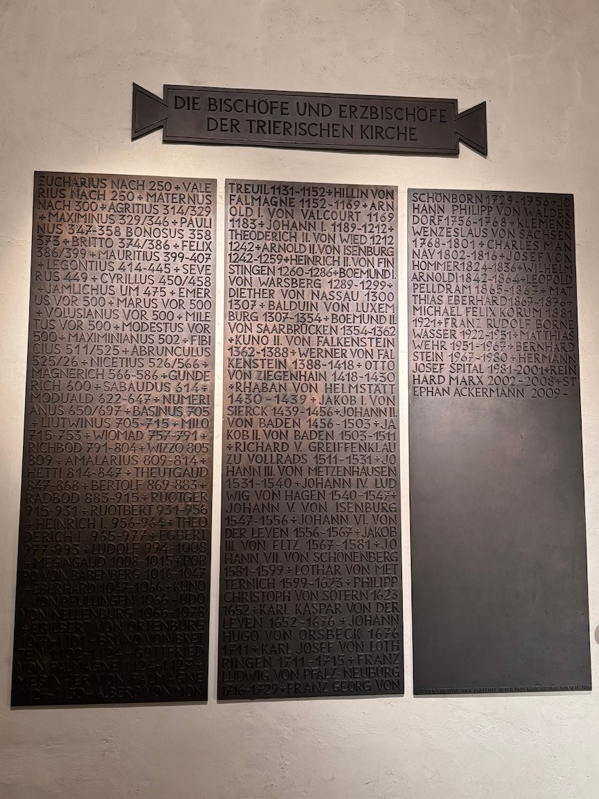 Dark plaques list the bishops and archbishops of Trier in the cathedral.