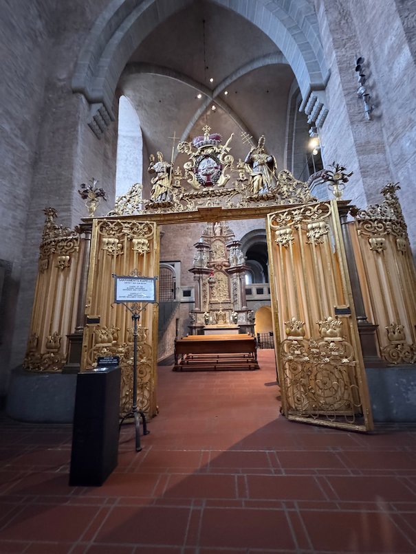 A golden gate leads into a chapel inside Trier Cathedral.