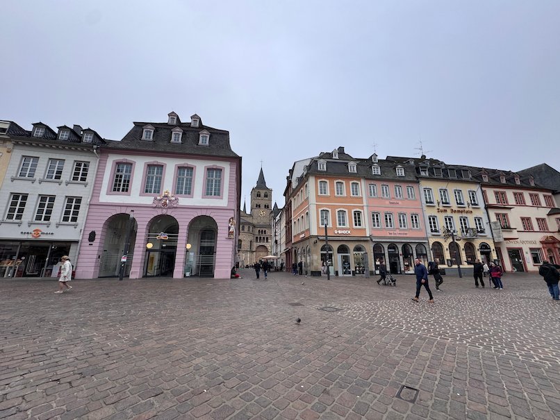 The Hauptmarkt square opens toward the tower of Trier Cathedral.