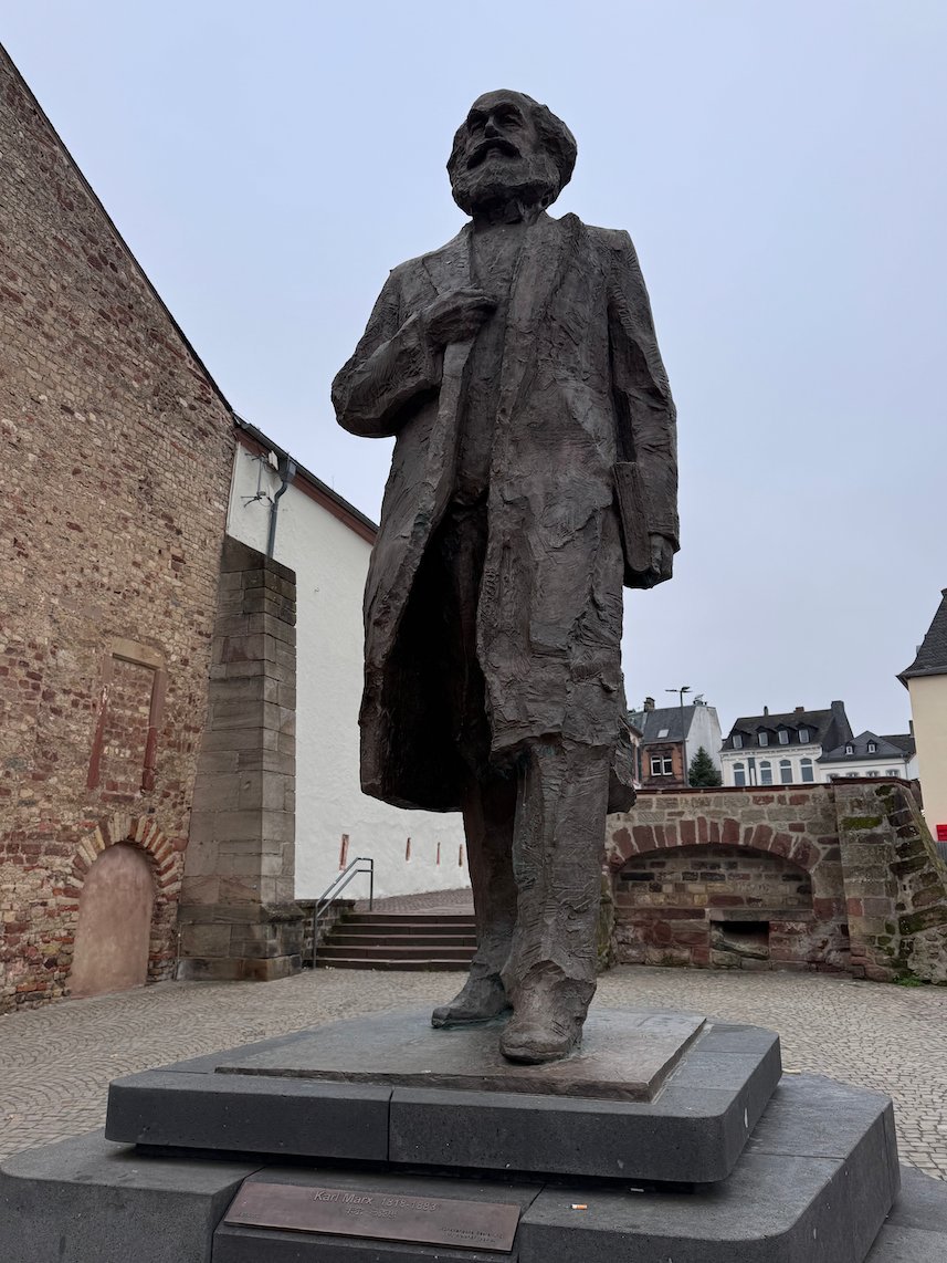 A large bronze statue of Karl Marx stands on a square in Trier, Germany.