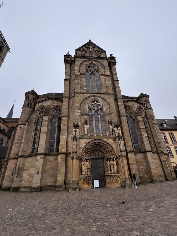 The west portal of the Church of Our Lady stands on a cobbled square in Trier.