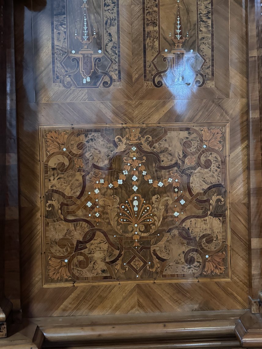 A wooden panel with inlaid ornaments and patterns is on display in Trier.